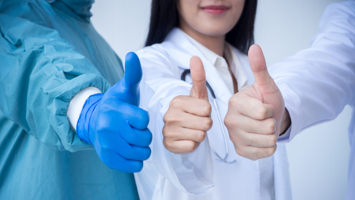 Doctors giving the thumbs up.