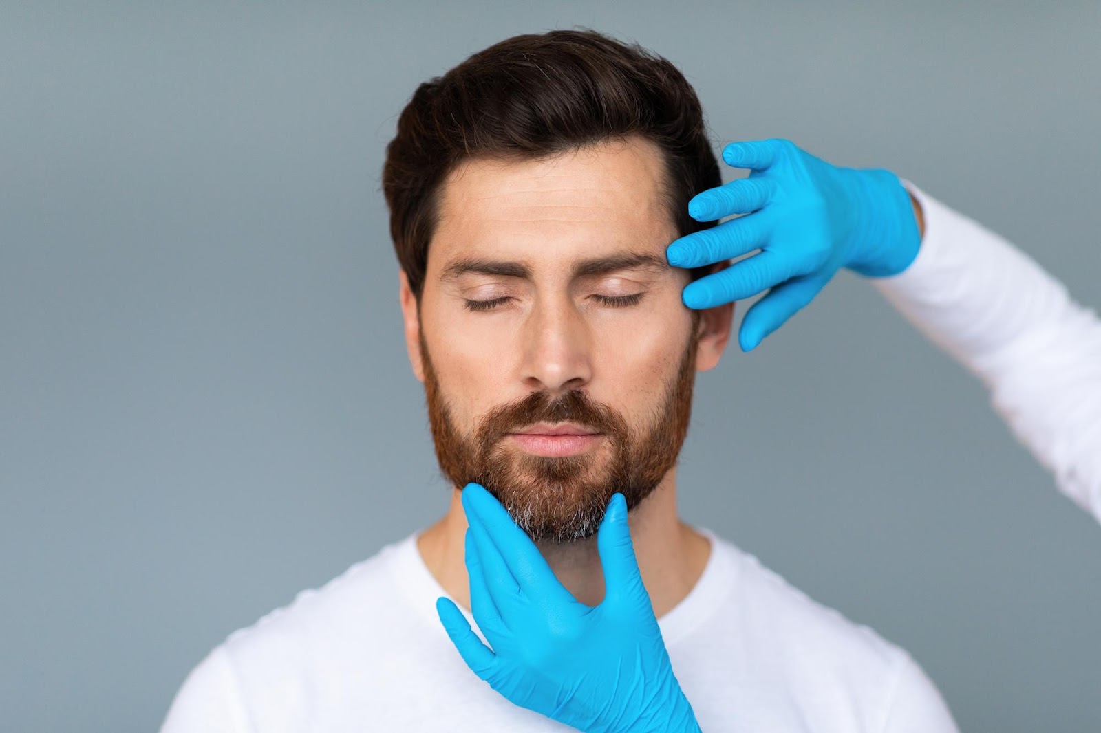 Aesthetic specialist analyzing the facial structure of a male patient interested in Radiesse treatment.