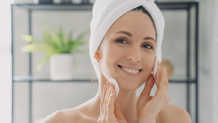 Woman following a skincare routine to maintain the results of her Radiesse injections.