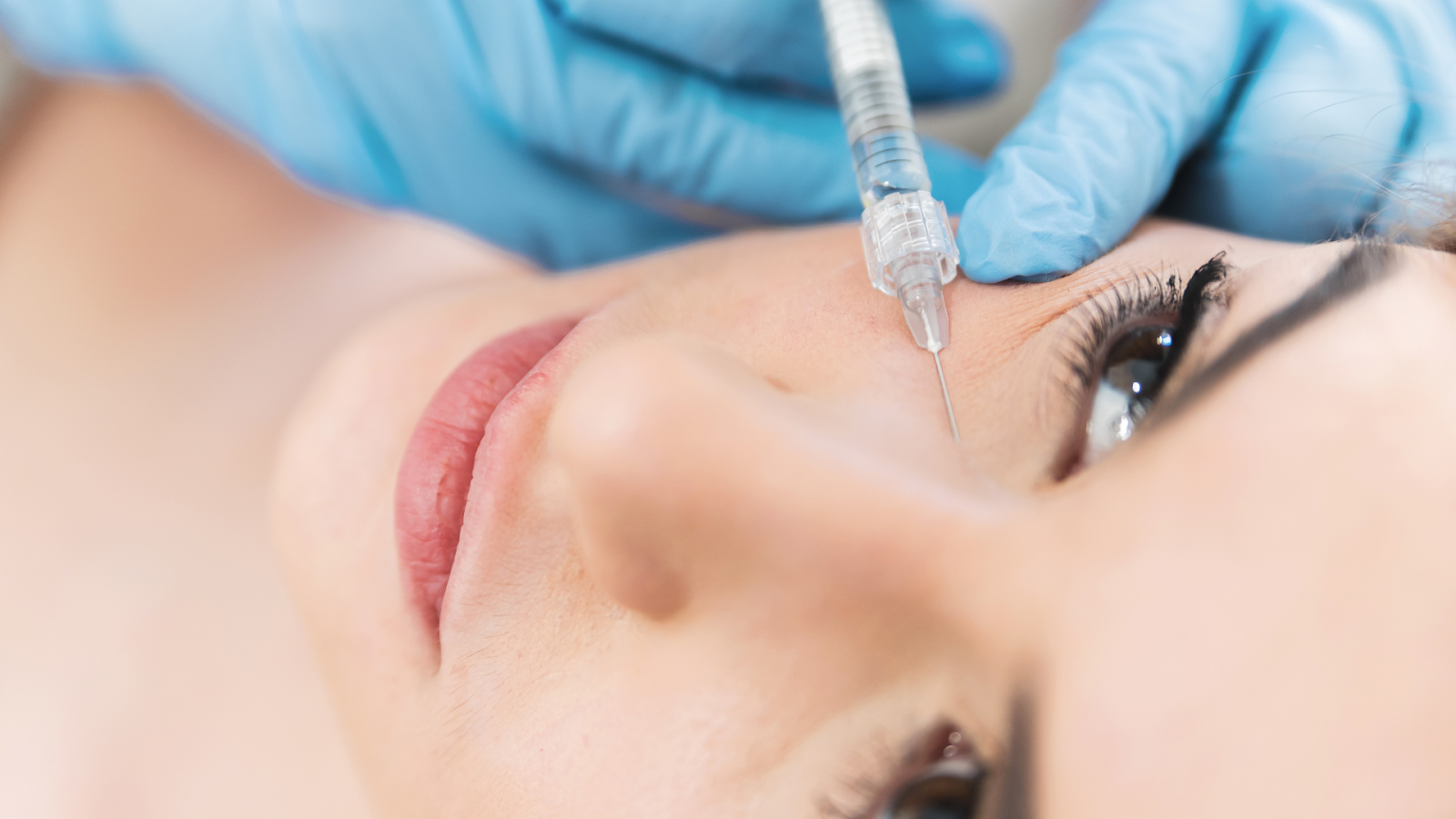 A female patient receives under eye injections to enhance and revitalize her appearance.